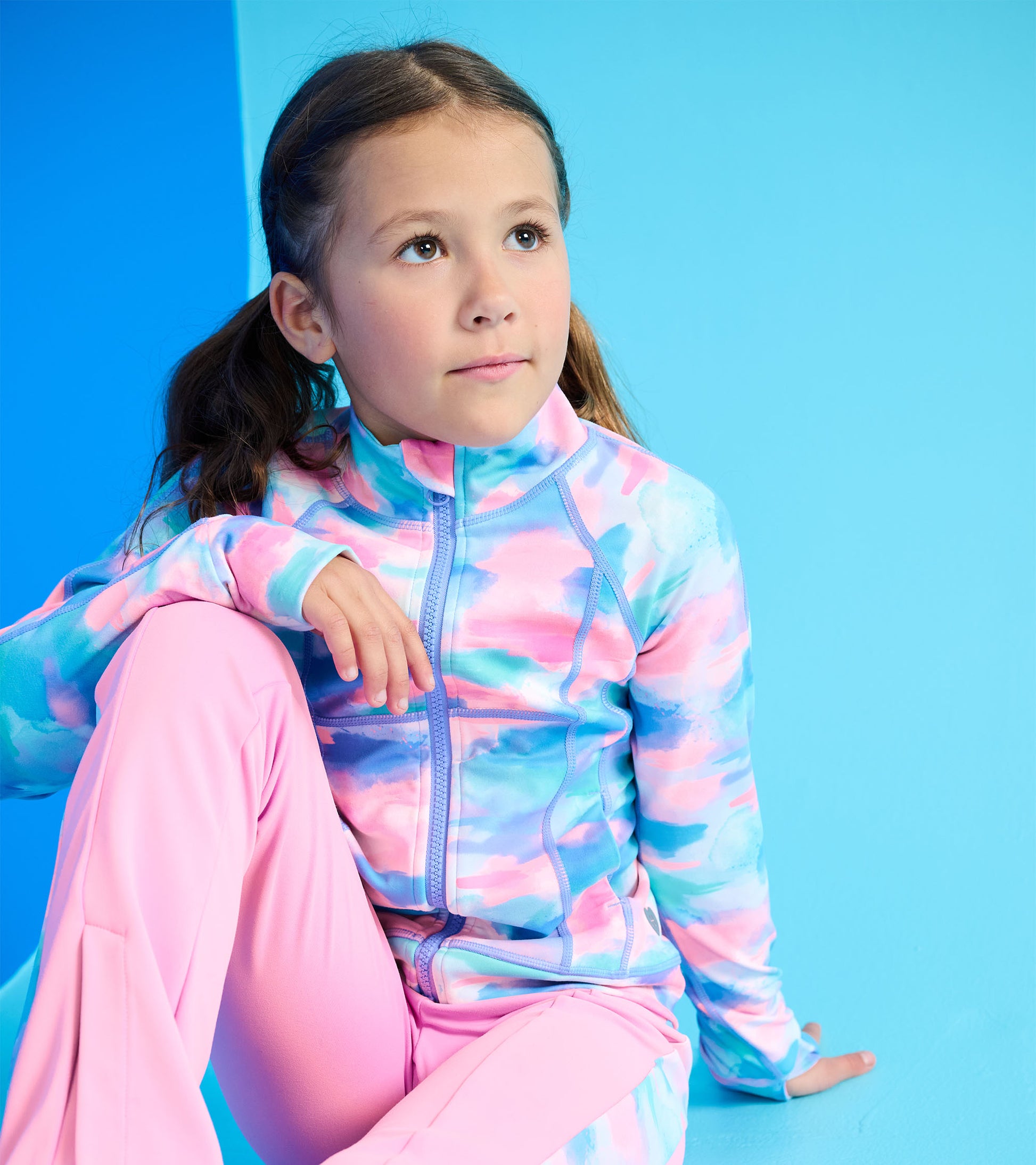 Colorful, lightweight active jacket featuring a pink and blue watercolor pattern, ideal for outdoor activities.