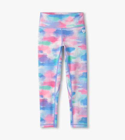 Colorful leggings featuring a watercolor pattern in pink, blue, and green, designed for active wear.
