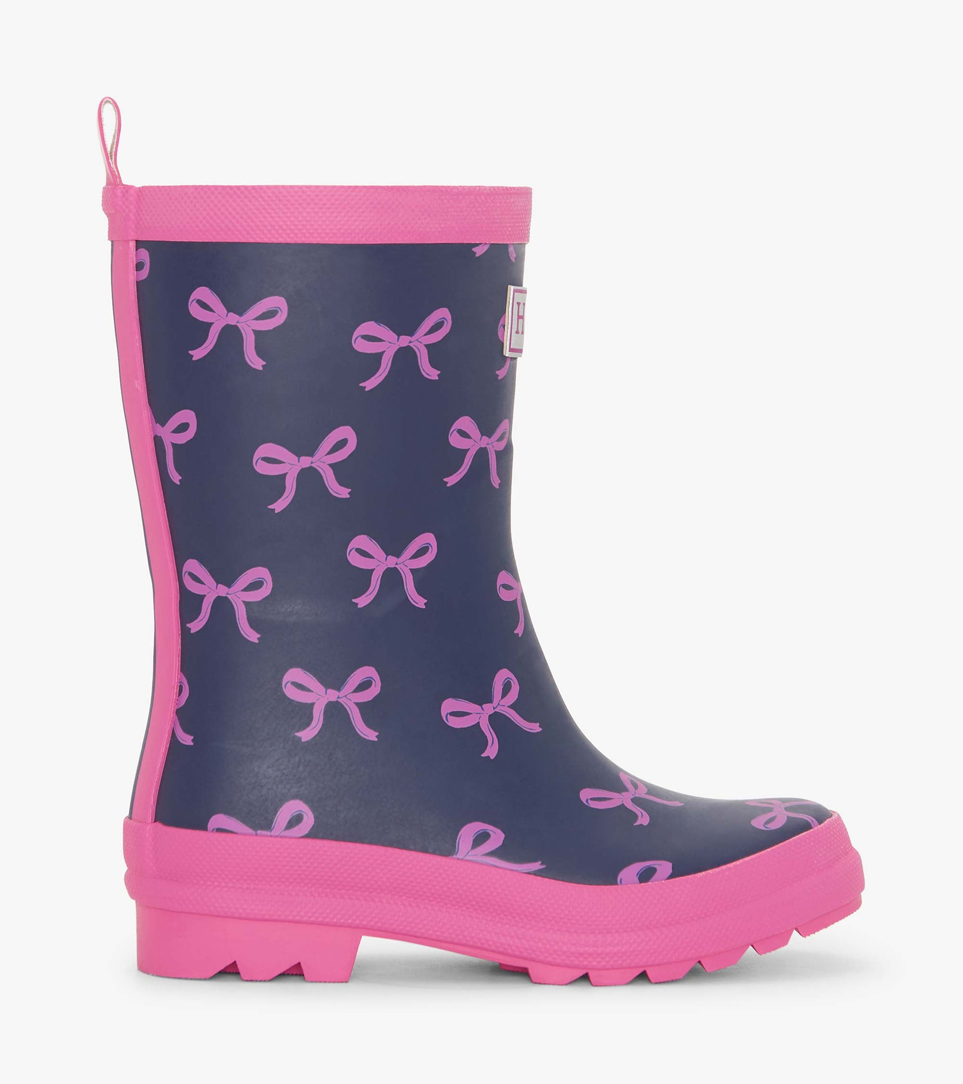 Matte navy rain boots with pink bow pattern and pink soles, designed for girls, featuring a pull tab for easy wear.