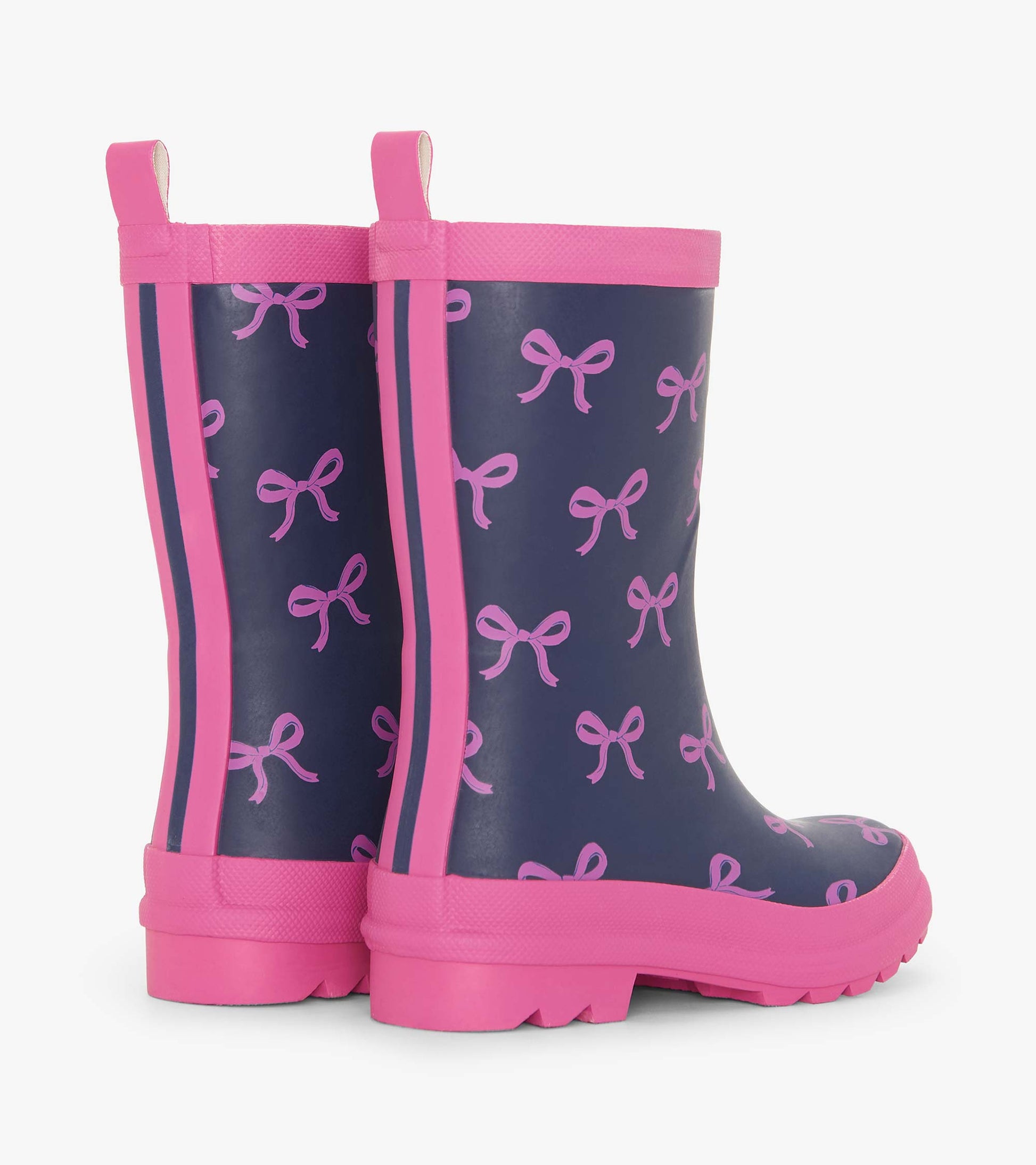 Navy rain boots with pink bow pattern and trim, featuring a sturdy sole and pull tabs for easy wear.