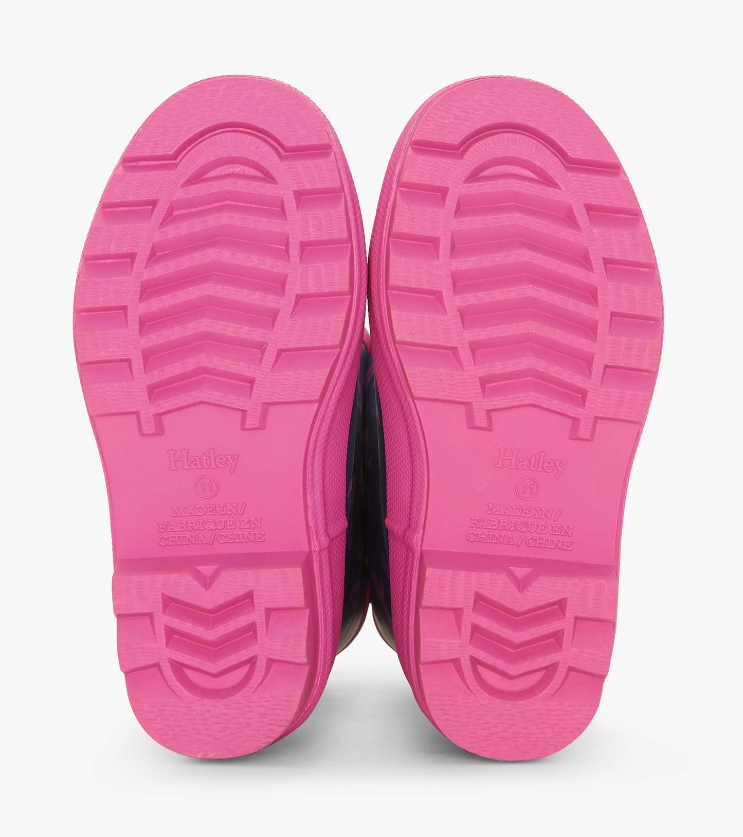 Pink rubber soles of rain boots with textured grip pattern, designed for kids.