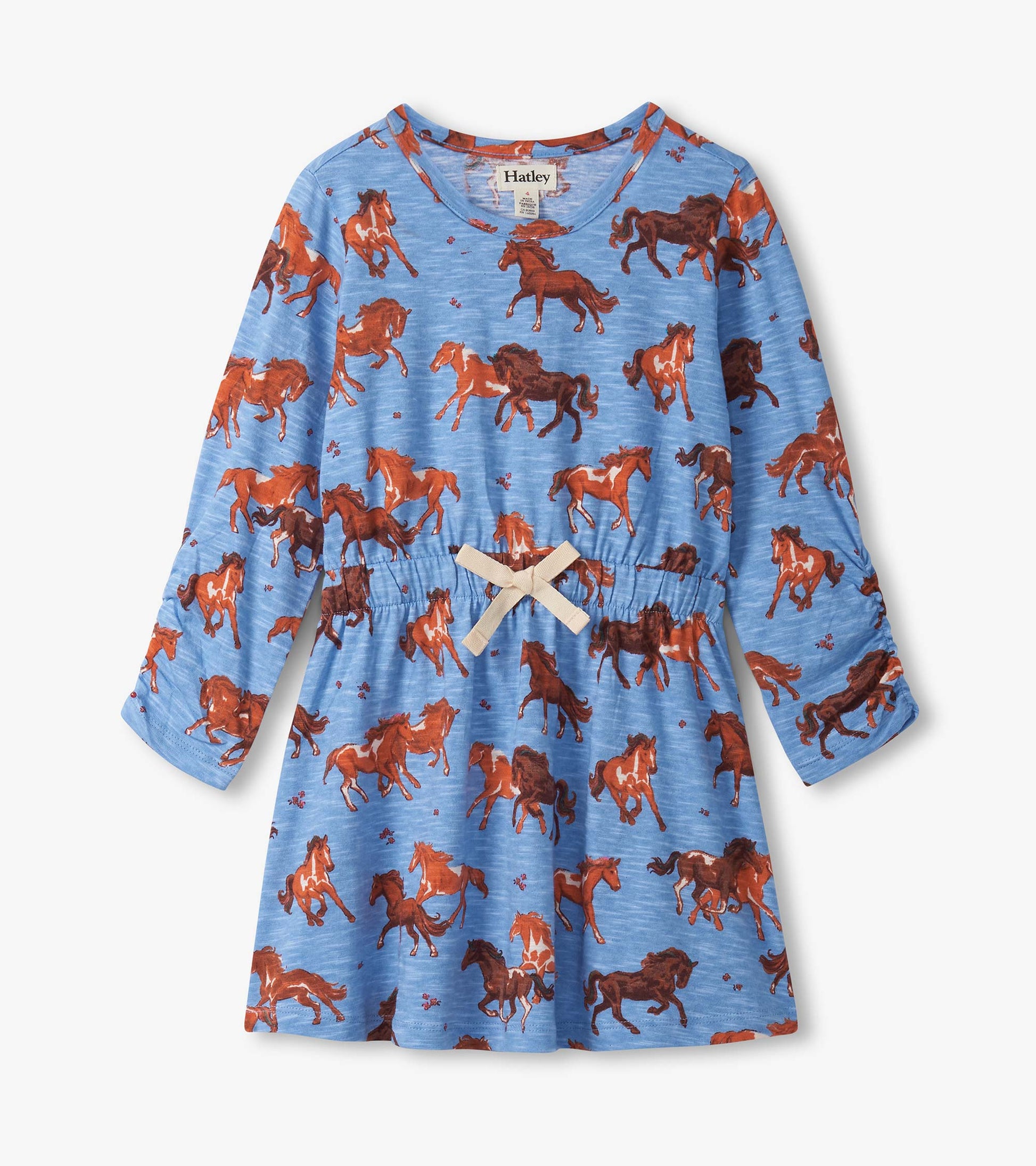Blue dress featuring a playful horse print, cinched waist, and long sleeves. Ideal for casual wear.