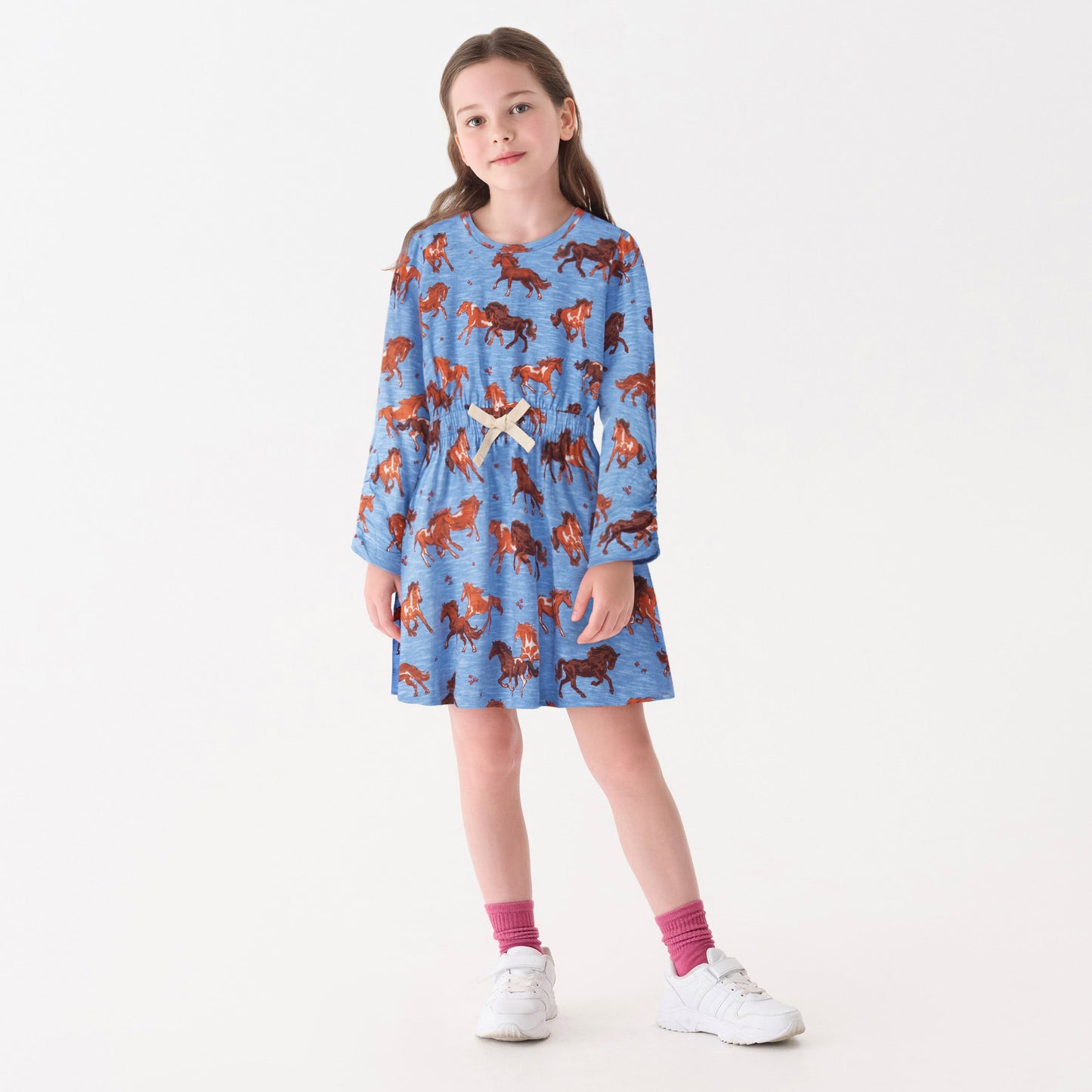 Blue dress featuring a horse print, cinched waist, and long sleeves, suitable for casual wear.