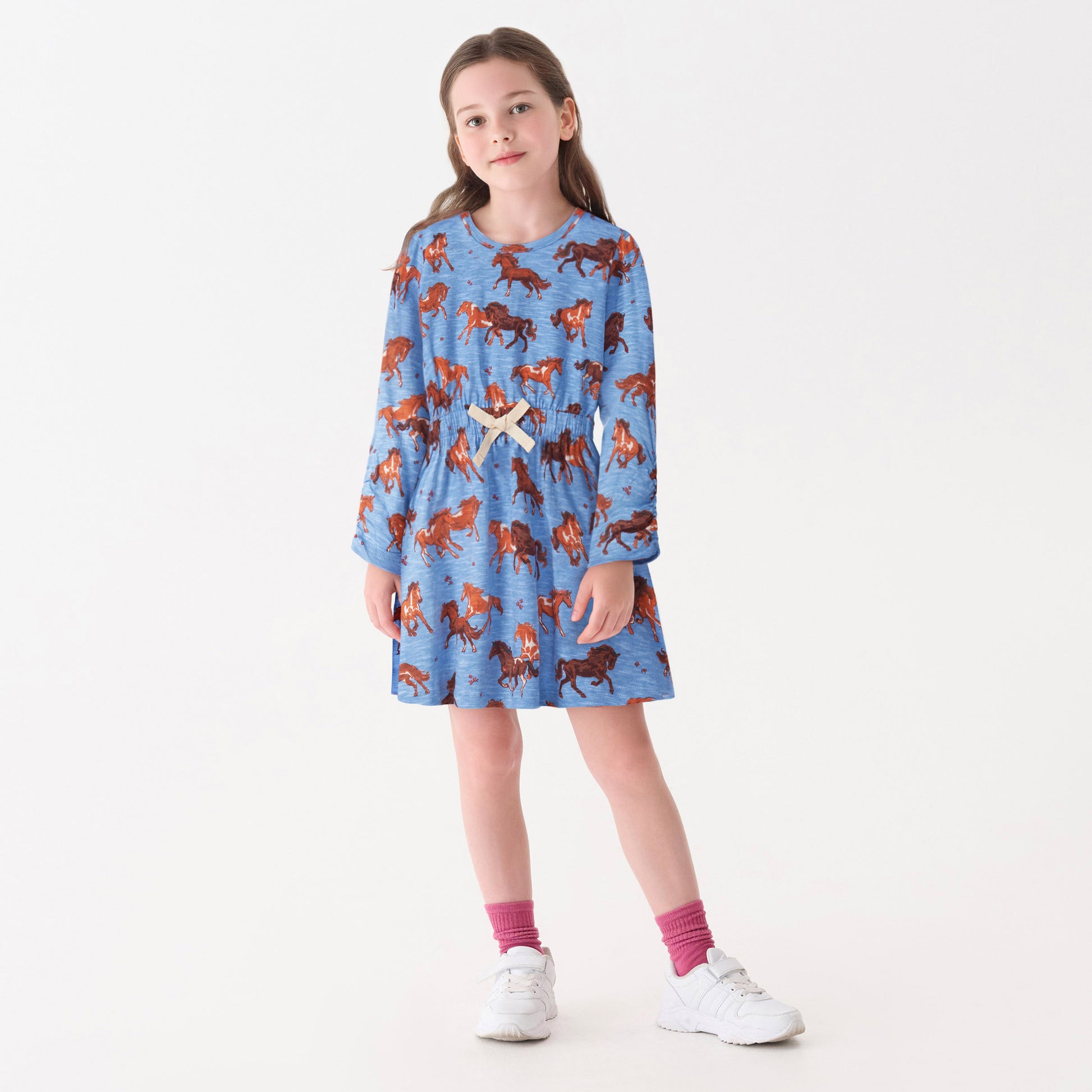 Blue dress featuring a horse print, cinched waist, and long sleeves, suitable for casual wear.