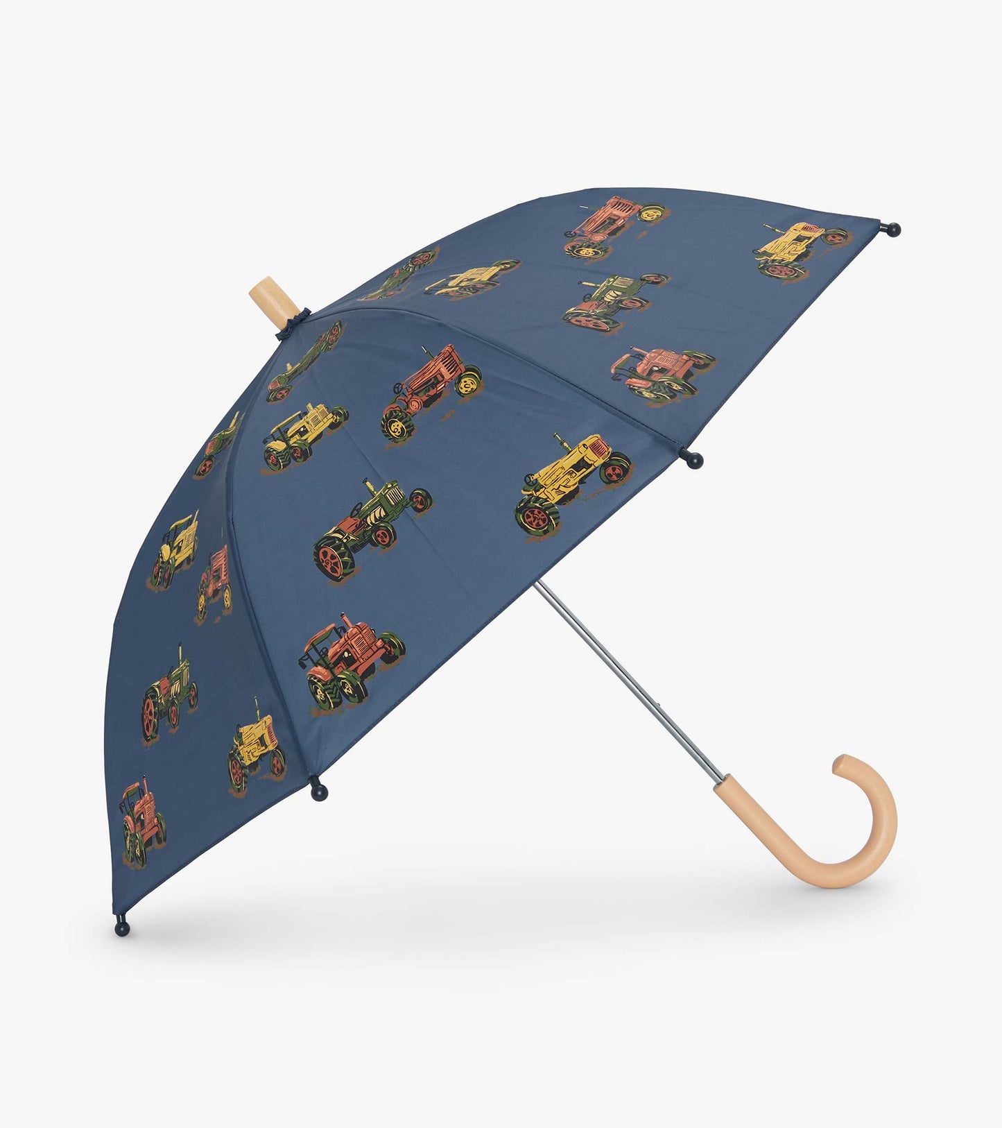 Navy umbrella featuring colorful tractor patterns, with a curved wooden handle and metal frame.