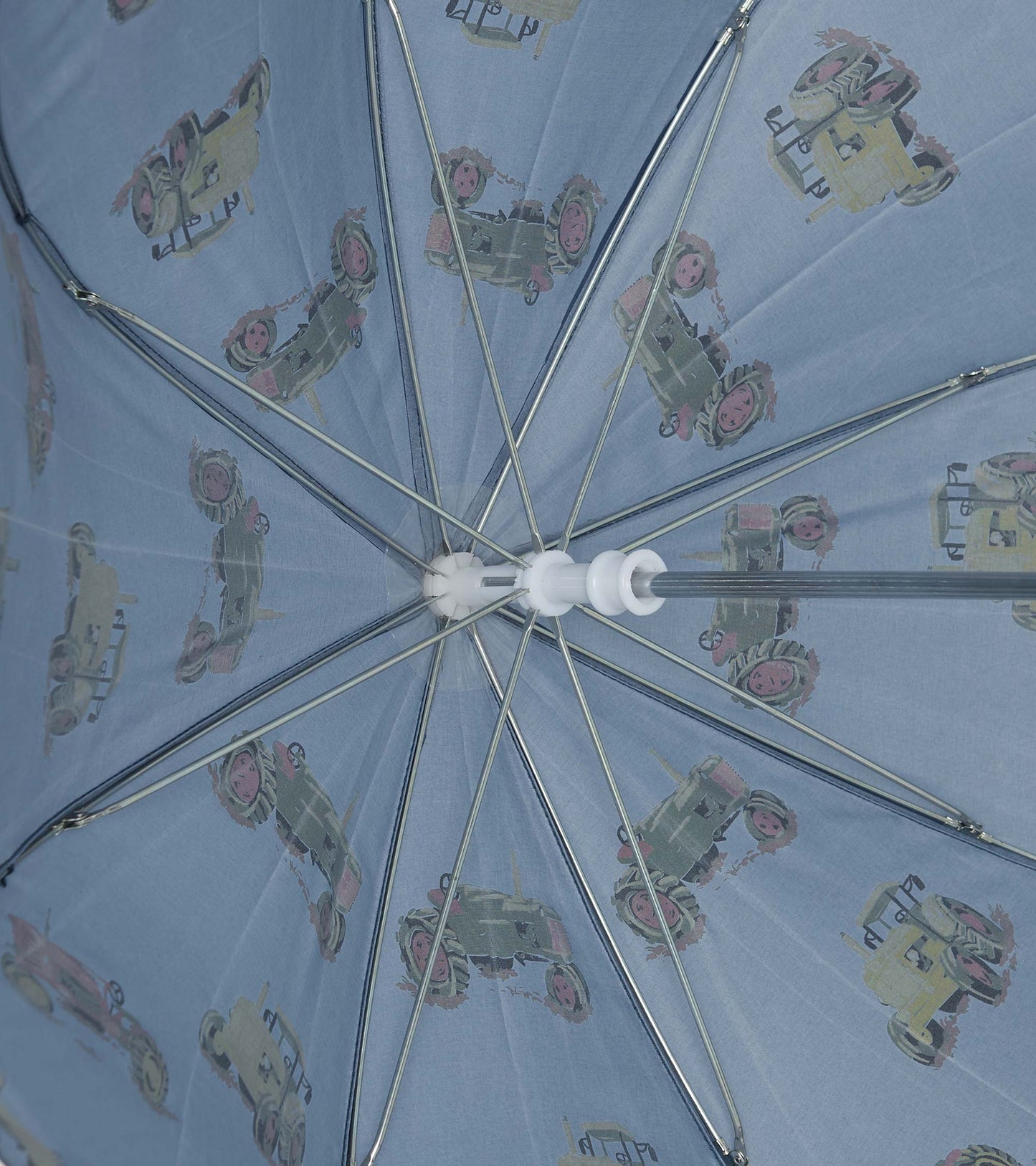 Light blue umbrella featuring a tractor pattern, designed for boys, with a sturdy metal frame and plastic handle.