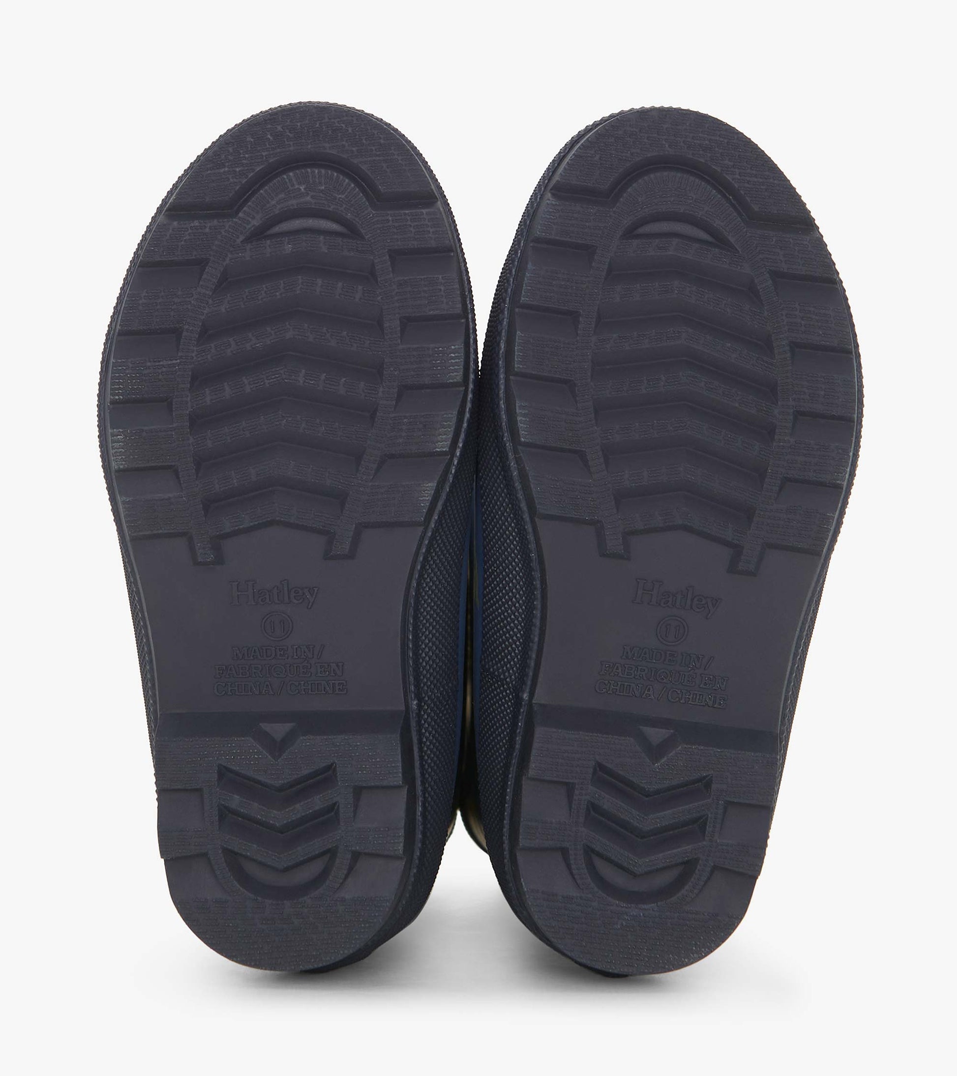 Matte navy rain boots with textured soles, designed for boys, featuring a landscape tractor pattern.