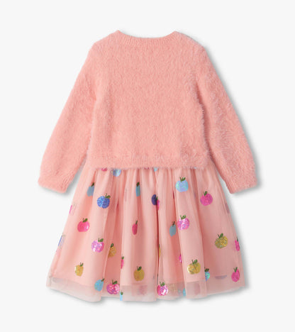 Back view of pink long-sleeve dress with fuzzy knit top and tulle skirt with colorful sequin apples