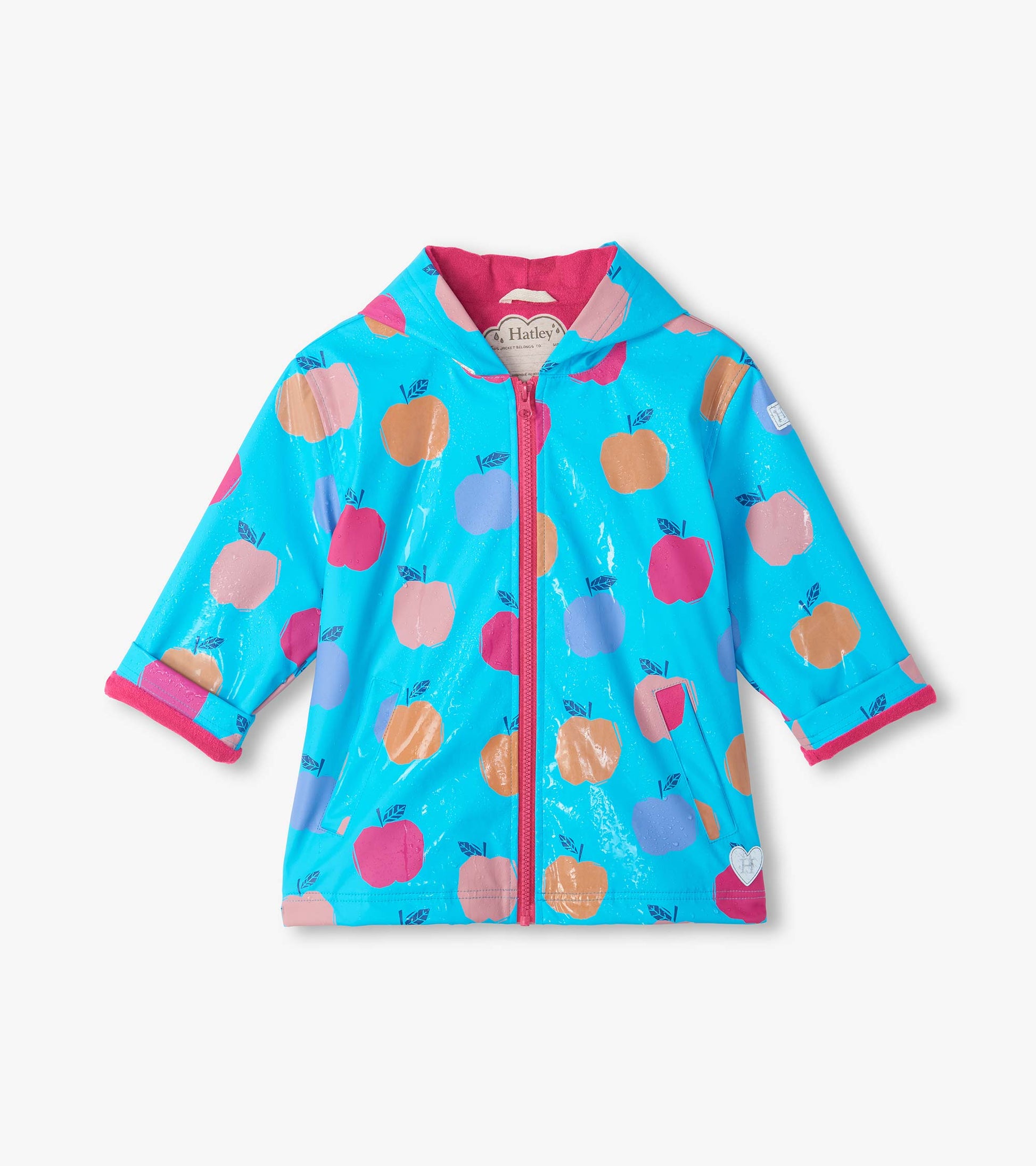 Front view of color change rain coat with blue background, pink zipper, and apples shifted to tan in wet areas