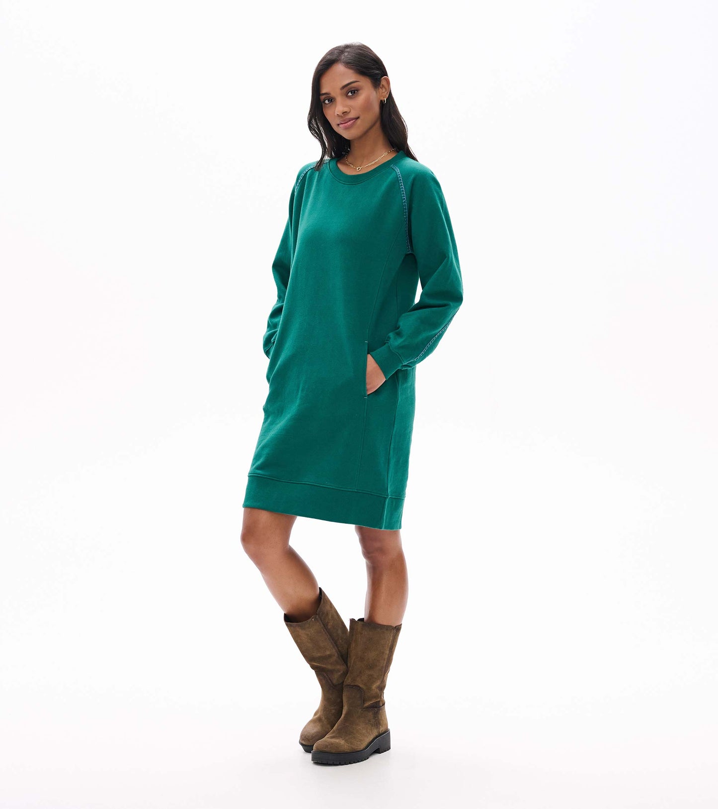 Three-quarter view of aventurine green sweatshirt dress with side pockets and contrast stitching
