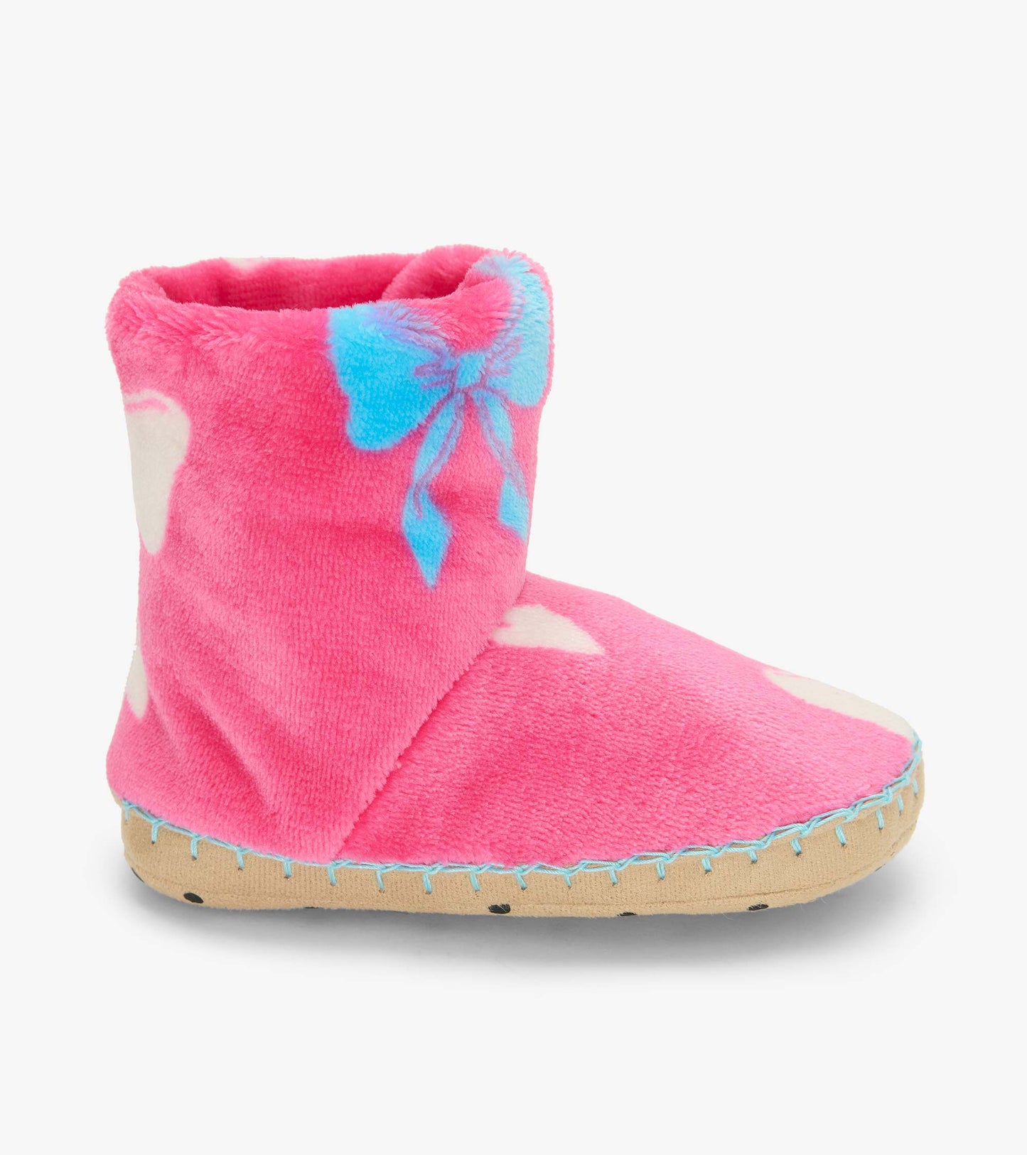 Side view of a pink fleece bootie slipper with blue bow print and tan sole