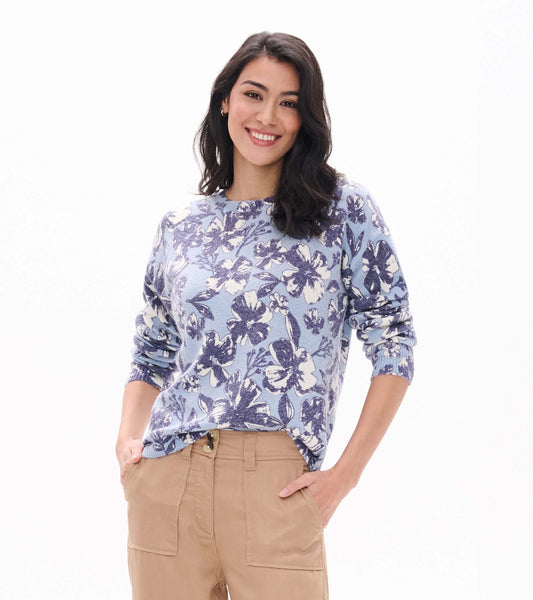 Front view of Noa sweater with light blue base and oversized navy and white floral print