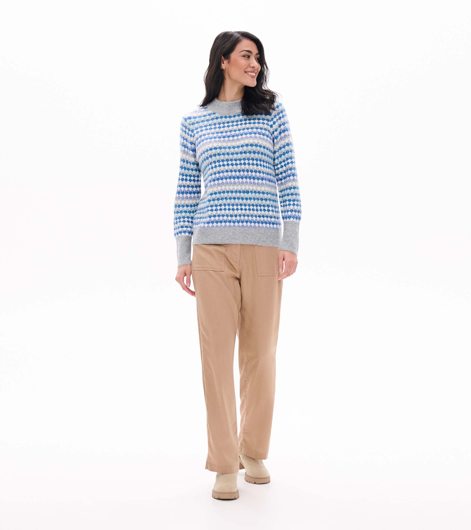 Full front view of blue ombre sweater with gray trim, styled with tan pants