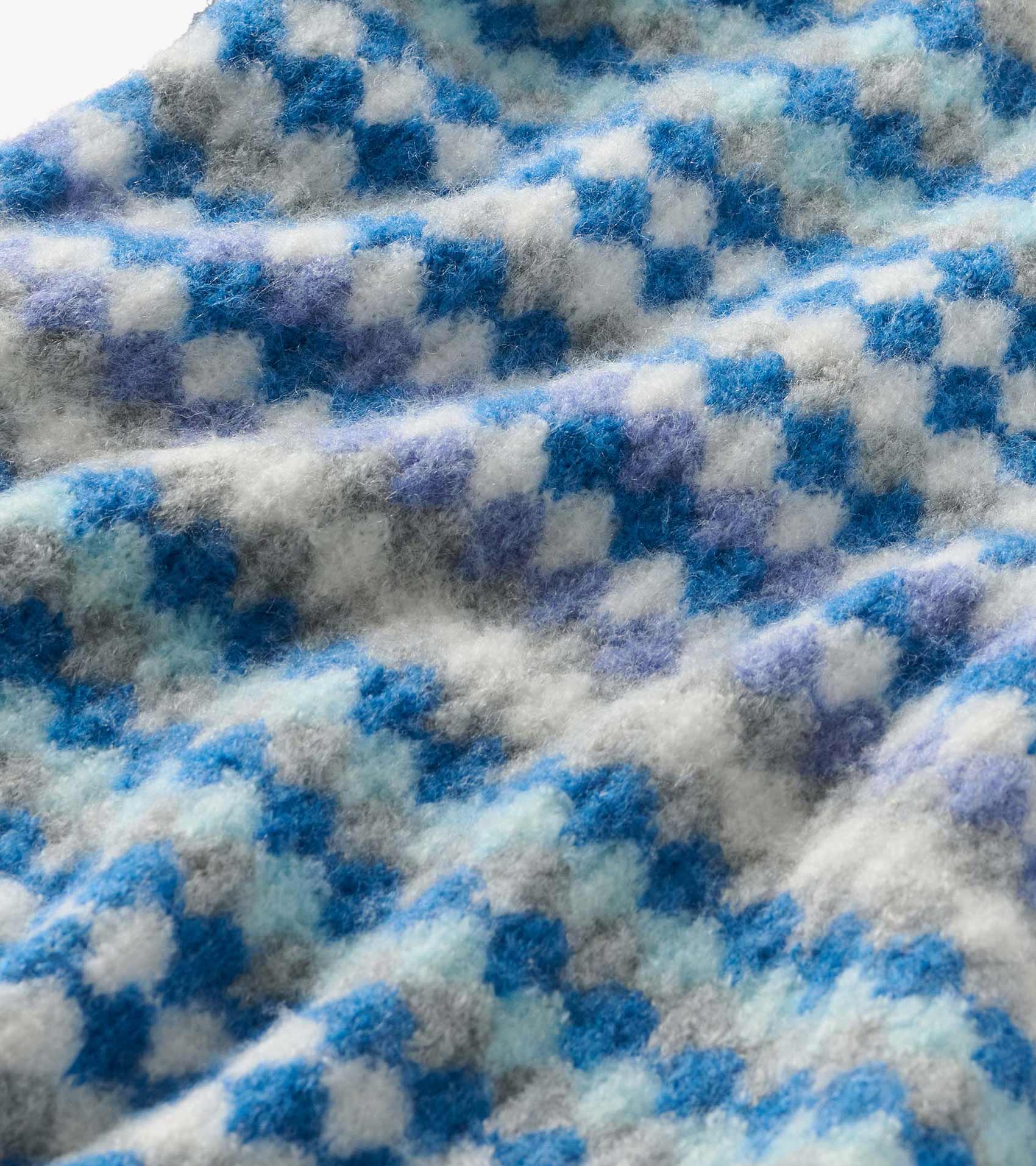 Close-up of blue, white, gray, and lavender ombre knit pattern on the sweater