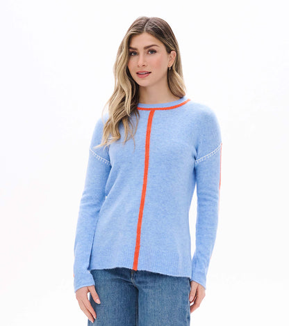 Front view of Maeve sweater in azure blue with orange center seam, orange trim, and white shoulder stitching