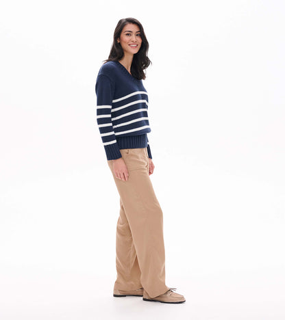 Side view of navy V-neck sweater with cream stripes and long ribbed cuffs