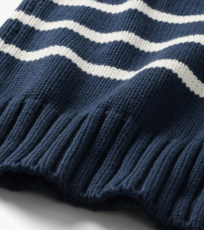 Close-up of navy sweater with cream stripes and wide ribbed hem