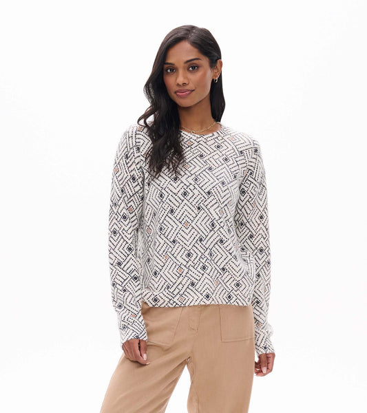 Front view of Noa sweater in cream with black geometric ikat pattern and small peach accents
