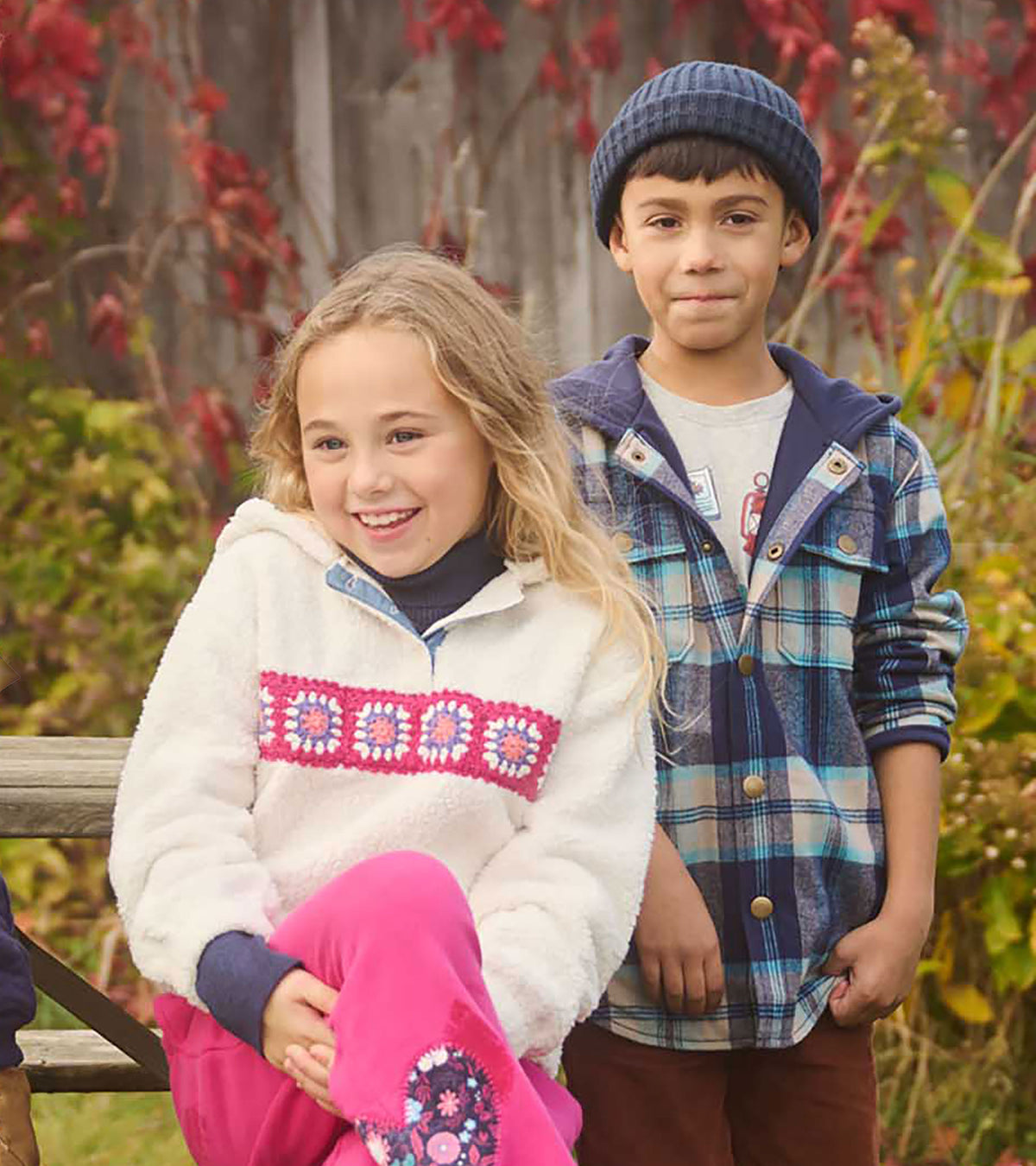 Boy wearing blue plaid hooded shirt jacket with navy beanie in outdoor group shot