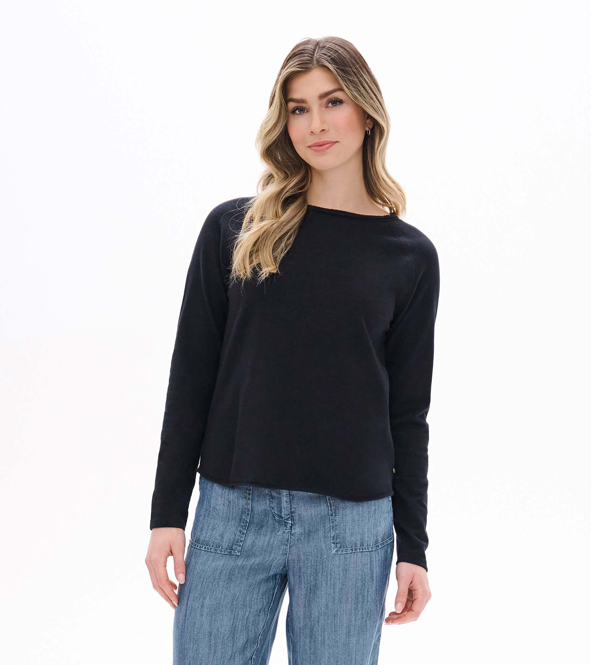 Front view of black raglan sleeve tee with long sleeves and a relaxed fit on model