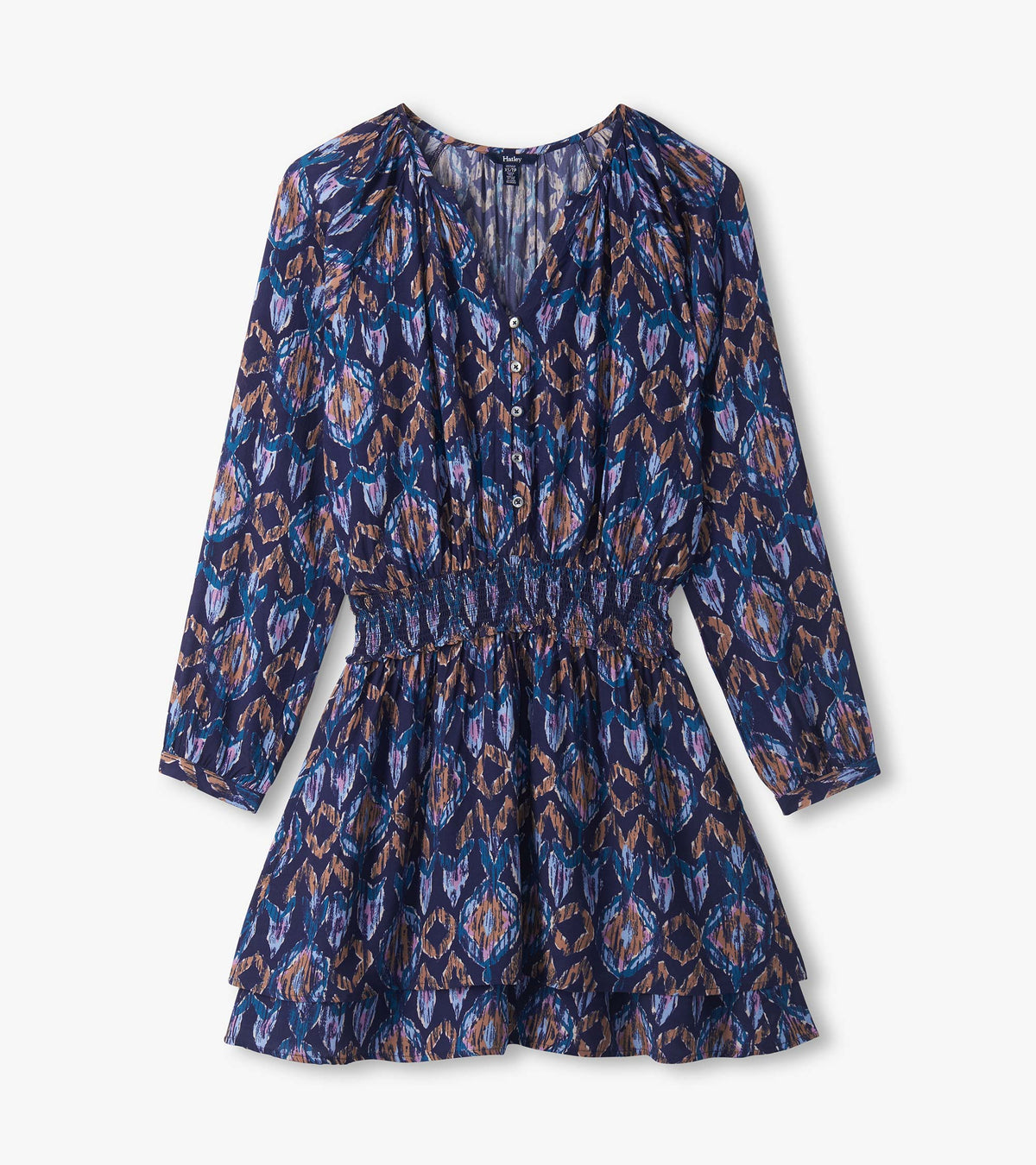 Close-up of mini dress with buttoned V-neck, long sleeves, smocked waist and blue, purple and tan ikat print