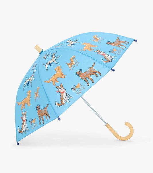 Open blue kids umbrella with multicolored dog print and curved pale handle, shown at an angle