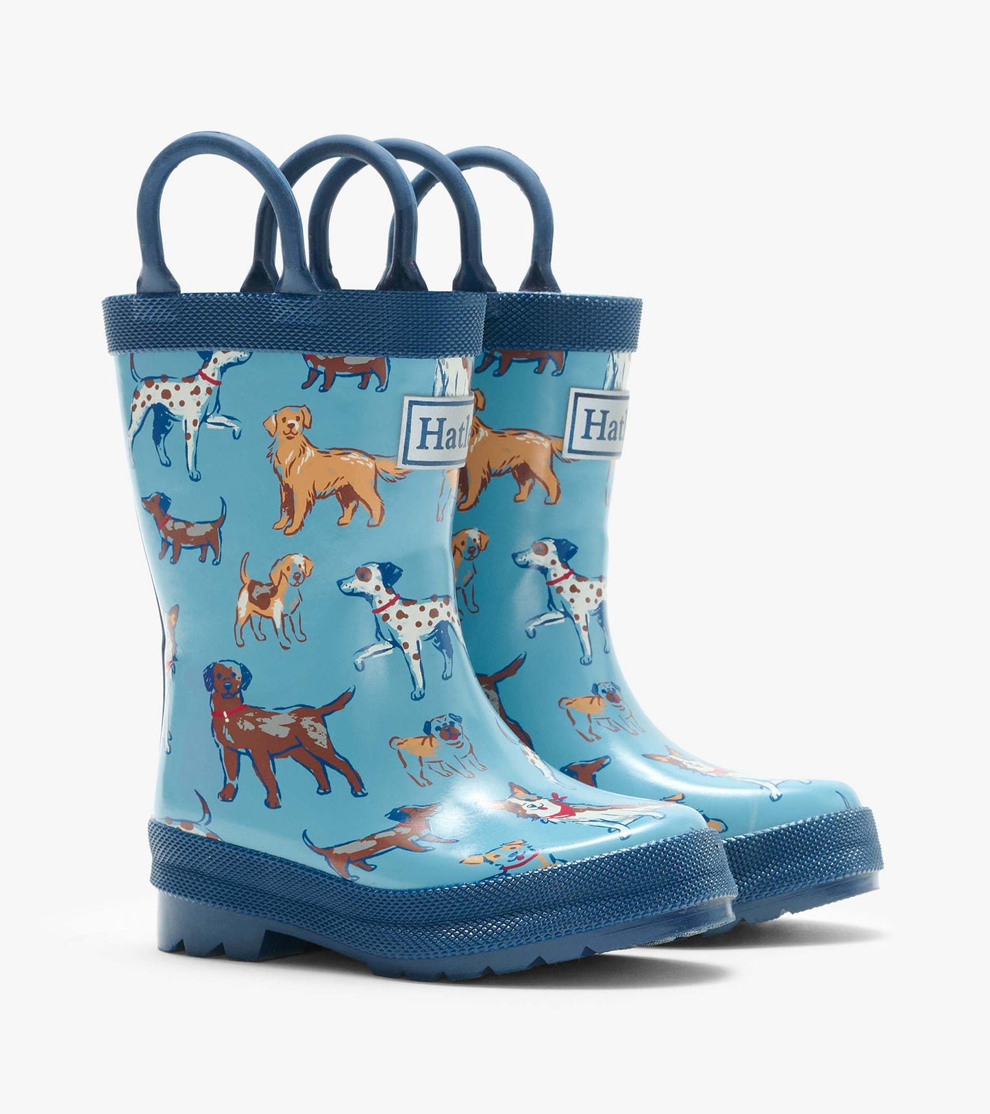 Pair of blue kids rain boots with navy handles and multicolored dog print, shown from the front