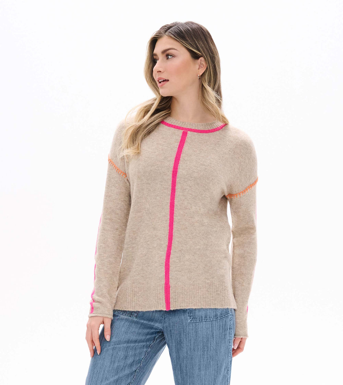 Model wearing oatmeal crewneck sweater with neon pink trim and center stripe, front view