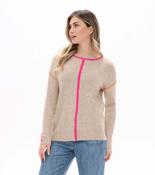 Model wearing oatmeal crewneck sweater with neon pink trim and center stripe, front view