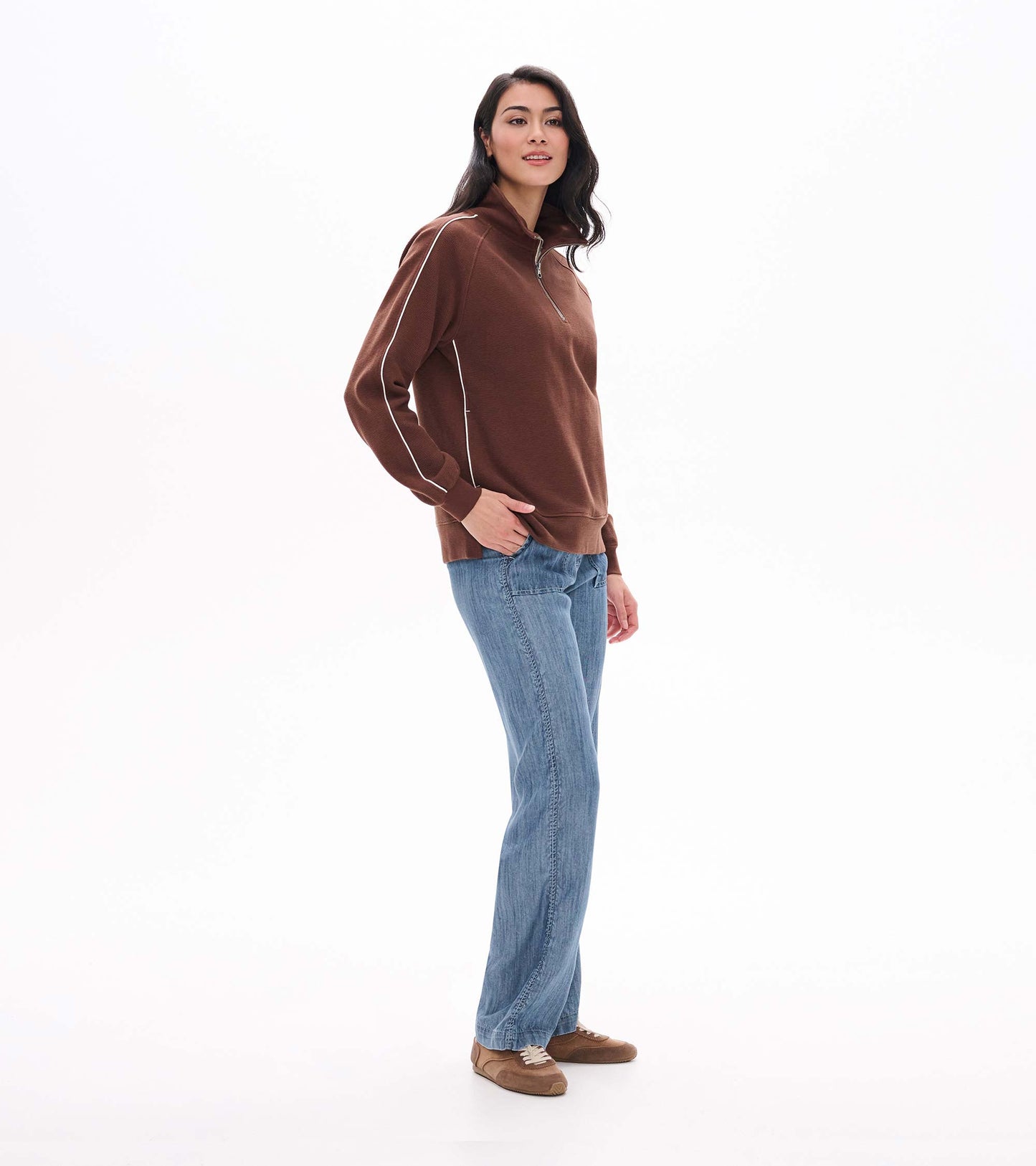Side view of fondue fudge brown 1/4 zip top with stand collar and white piping on the sleeves