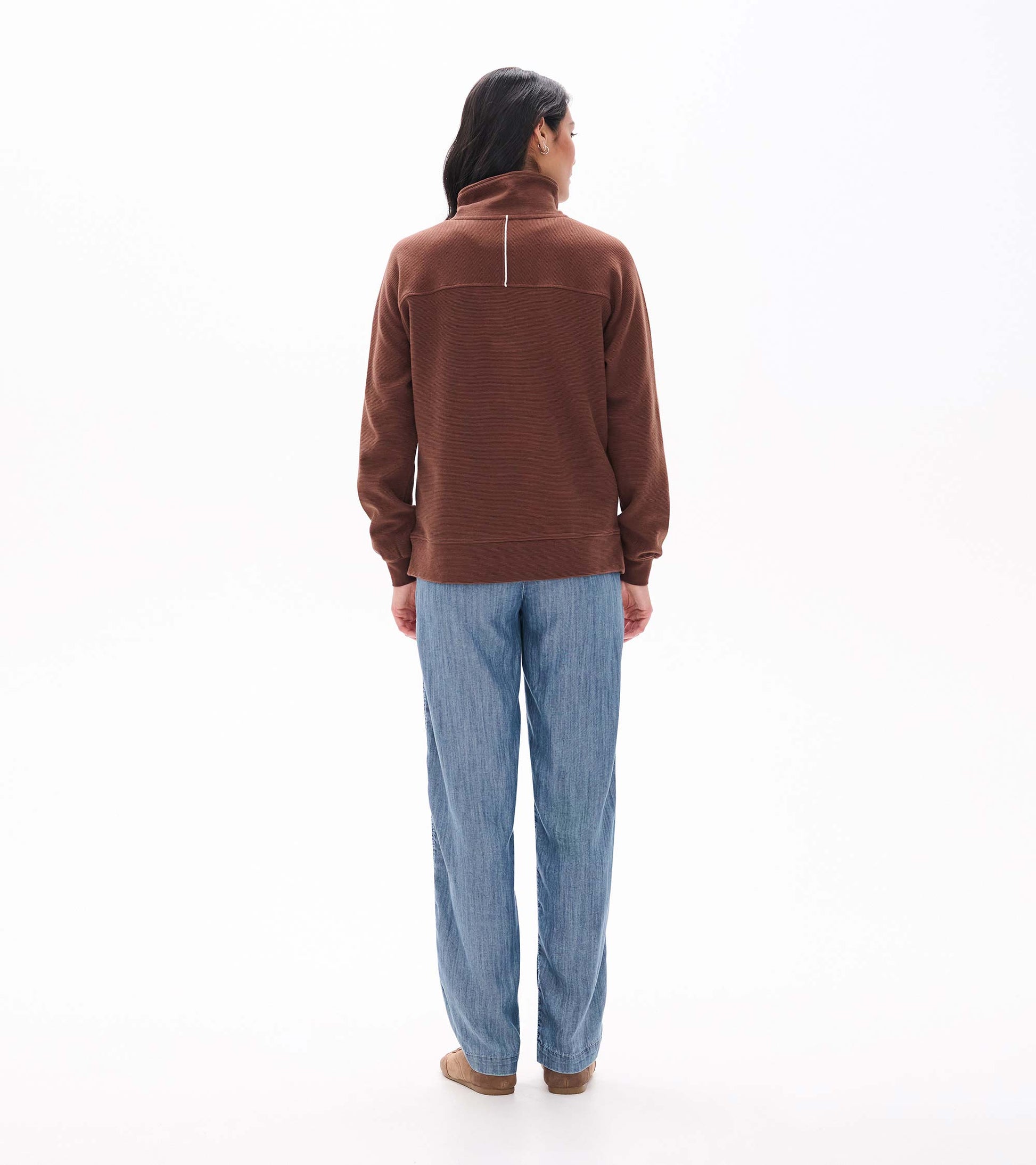 Back view of fondue fudge brown 1/4 zip top with stand collar and a vertical white detail at the neck