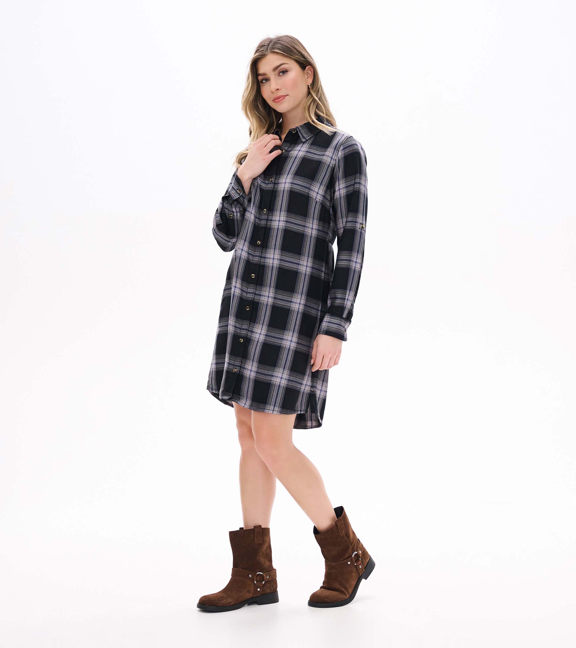 Angled front view of black and tan plaid shirt dress with long sleeves and button front
