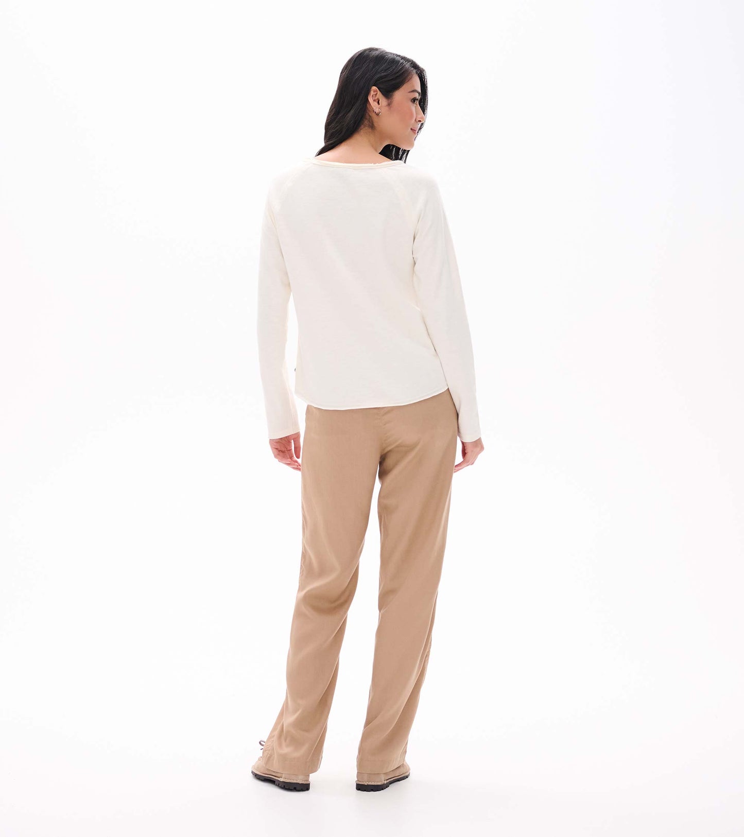 Back view of cream long sleeve raglan tee with a wide neckline, shown on model