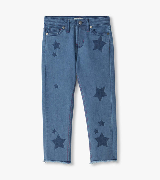 Front view of blue slouchy jeans with dark star print, five-pocket styling, and frayed hems