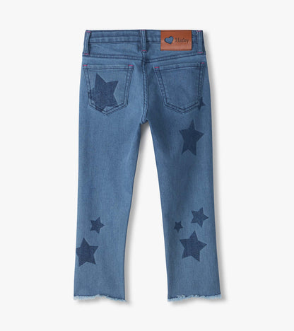 Back view of blue slouchy jeans with dark star print, back pockets, frayed hems, and visible Hatley patch