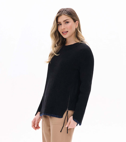 Black raglan sweater worn front view with side zipper, split hem, and blue stitched trim at the hem