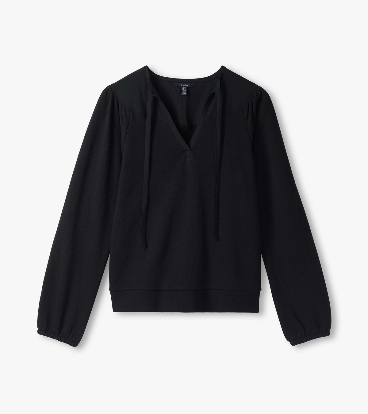 Black long sleeve top laid flat with split neckline, long ties, puffed shoulders, and banded hem