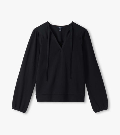 Black long sleeve top laid flat with split neckline, long ties, puffed shoulders, and banded hem