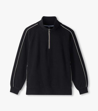 Black 1/4 zip knit top laid flat with stand collar, ribbed hem, and white piping on raglan sleeves