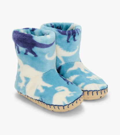 Pair of blue slipper boots with white and navy dinosaur silhouettes and tan stitched soles