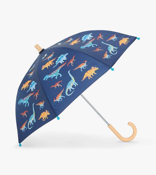 Open navy kids umbrella with colorful dinosaur print, blue tips, and a curved light wood-look handle