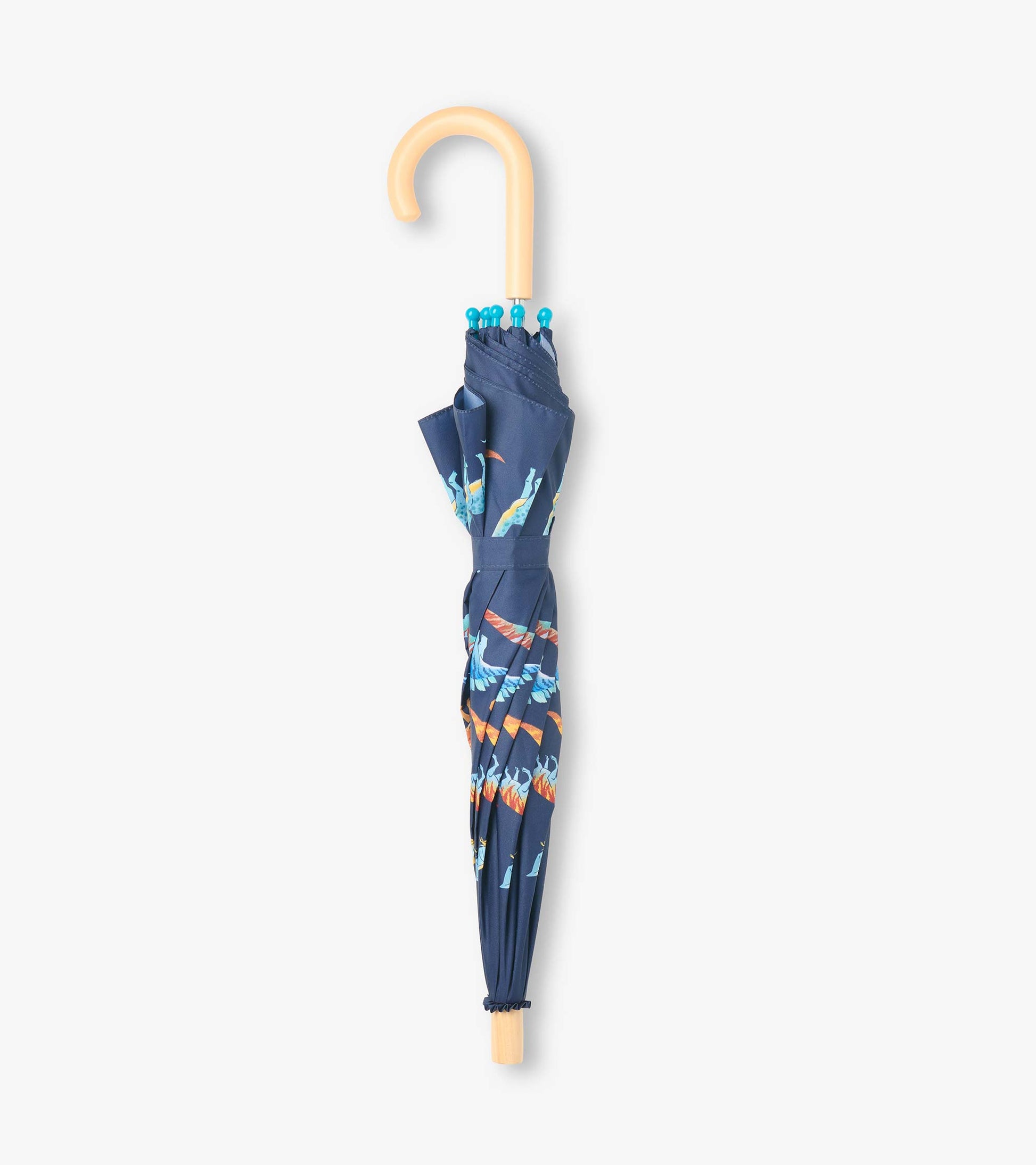 Closed navy dinosaur-print umbrella with blue safety tips and a curved light wood-look handle