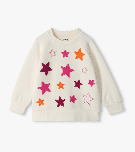 Cream slouchy pullover with colorful stitched star appliques on the front and long raglan sleeves