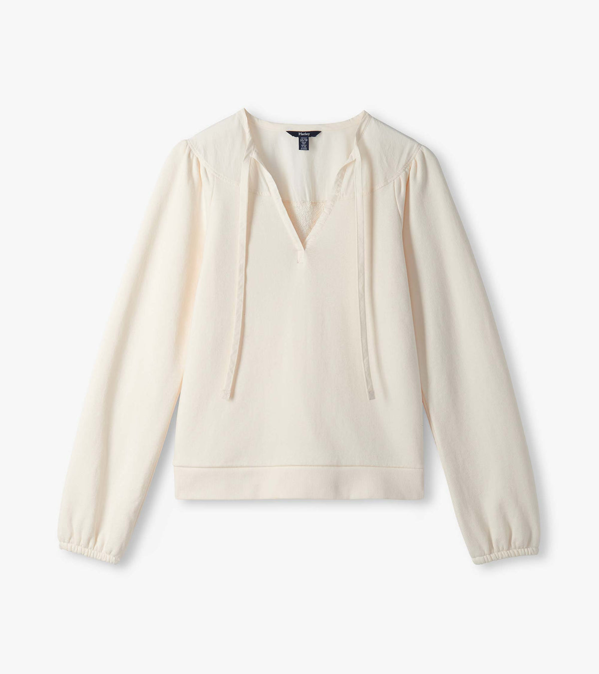 Cream long sleeve top laid flat with V neckline, tie detail, and gathered cuffs