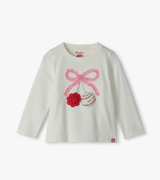 Cream long-sleeve toddler T-shirt with pink bow and ornament graphic on the front