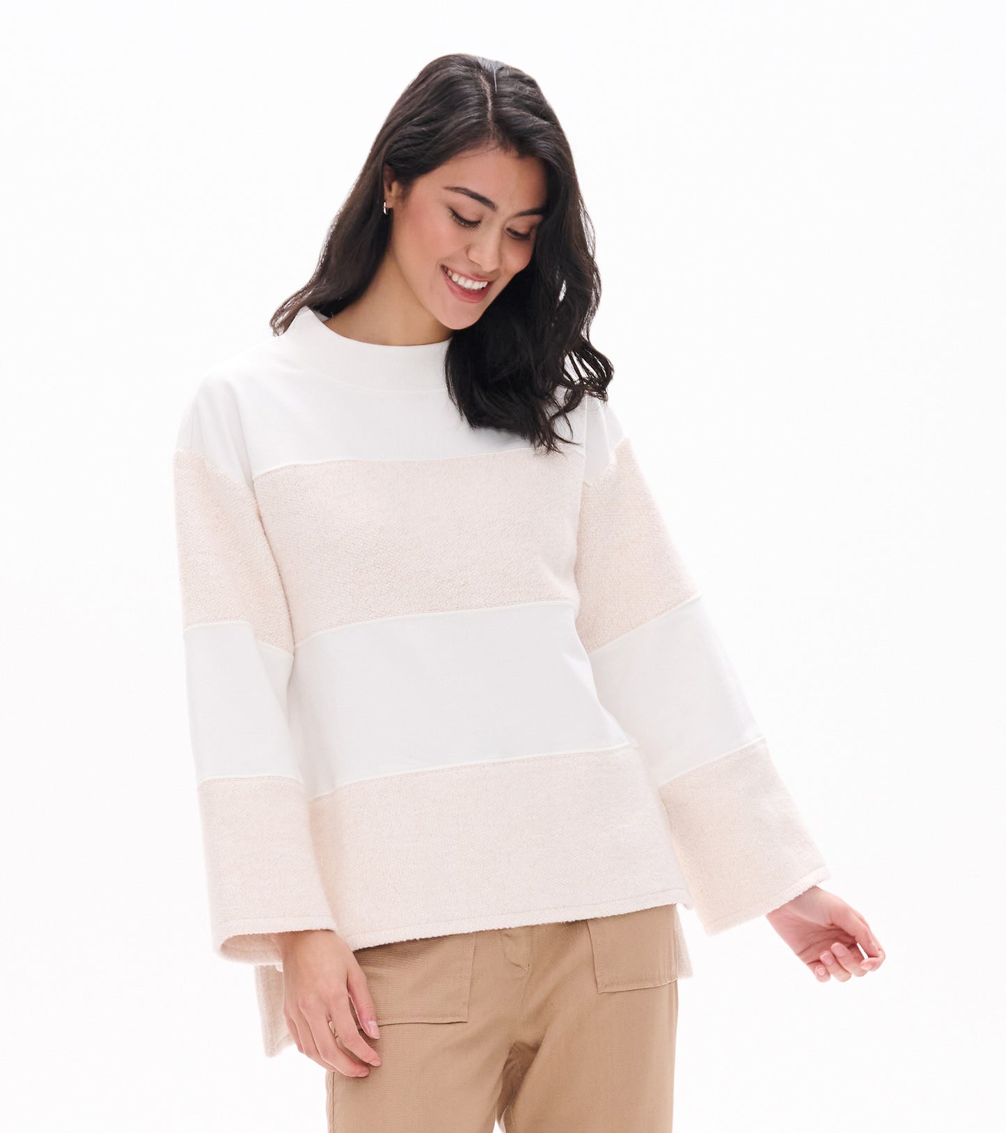Front view of oatmeal long sleeve top with wide horizontal panels and textured stripe sections