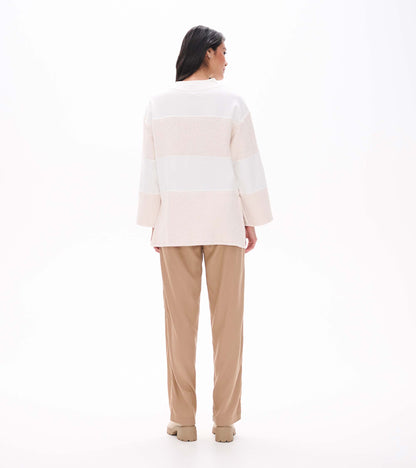 Back view of oatmeal long sleeve top with textured horizontal stripe panels and relaxed fit