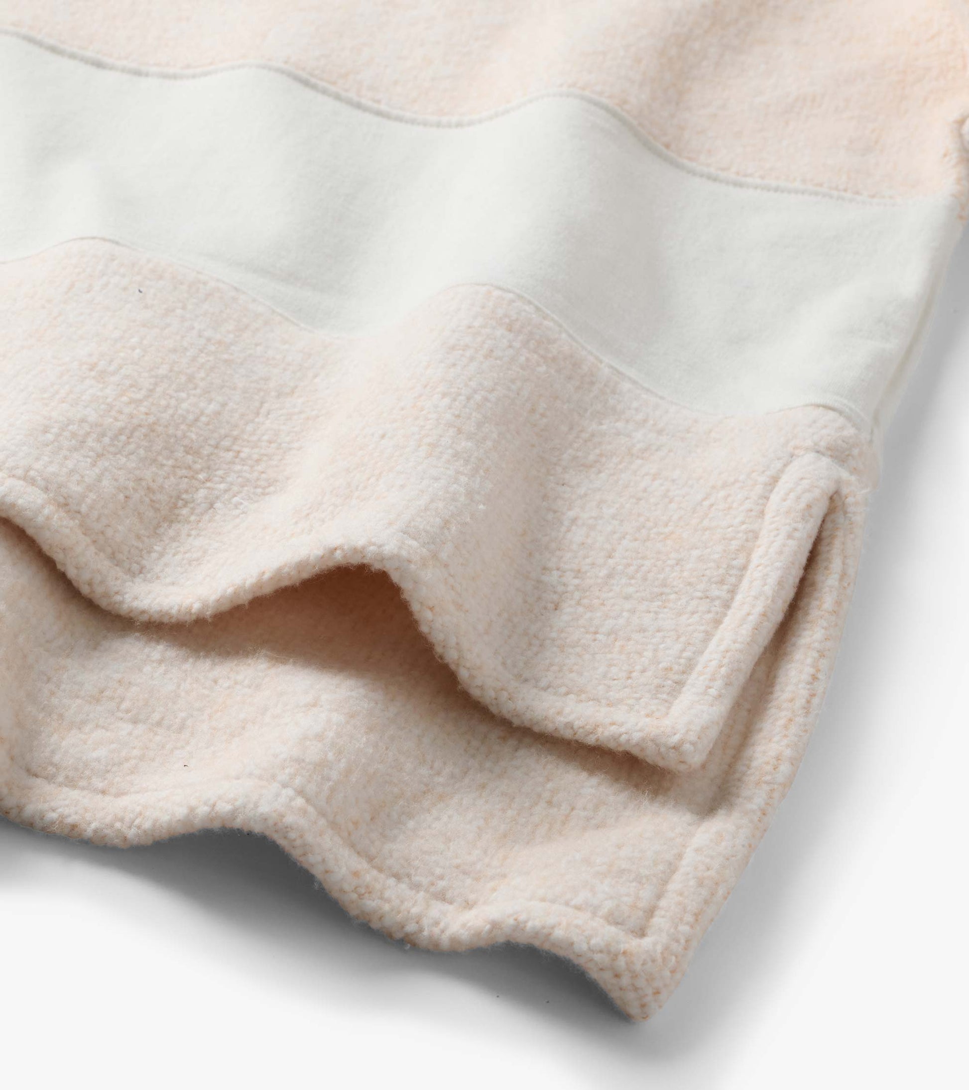 Close-up of oatmeal long sleeve top showing textured stripe panel and wide sleeve detail