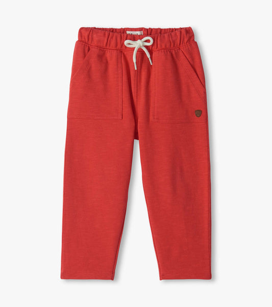 Infant pull-on pants in chrysanthemum red with elastic waistband, white drawstring, and front patch pockets