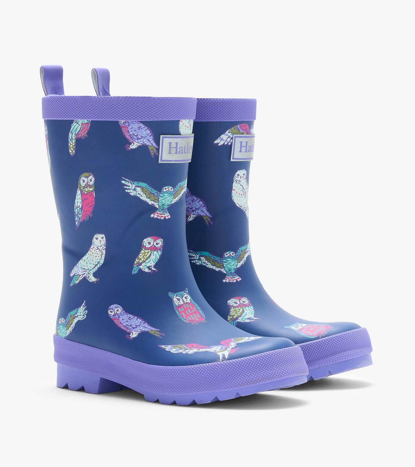 Pair of navy kids rain boots with colorful owl print, purple trim, and lug soles, shown from the front